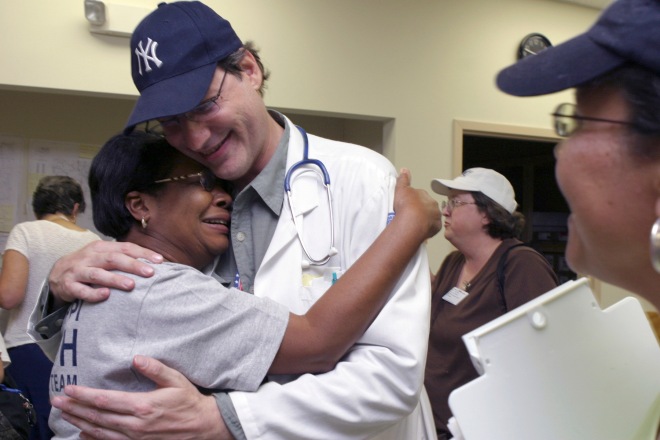 GULFPORT, MS -- SEP 9. 2005: GULFPORT, MS -- SEP 9, 2005: DR. Alan Manevitz, psychiatrist from New York, New York, embraces Frances Fields, epidemiology nurse, district two of Tupelo, Mississippi. Both are members of the Mississippi Emergency Agencies on the gulf coast. Photo: Ana Elisa Fuentes for the New York TImes.