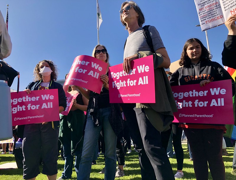 Thousands gathered in civic engagement to vocalize opposition to the current Supreme Court decision to Roe. v. Wade in San Francisco, on Friday, June 24, 2022. Here, citizens hold bright magenta signs from Planned Parenthood which read, "Together We Fight For All"