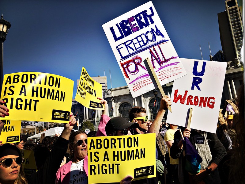 Thousands gathered in civic engagement to vocalize opposition to the current Supreme Court decision to Roe. v. Wade in San Francisco, on Friday, June 24, 2022. Here, citizens raise bright yellow signs from Amnesty International which read, "Abortion is a Human Right."